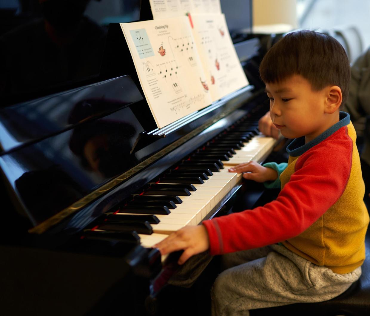 Instrument Petting Zoo - young boy tries piano