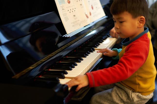 Instrument Petting Zoo - young boy tries piano